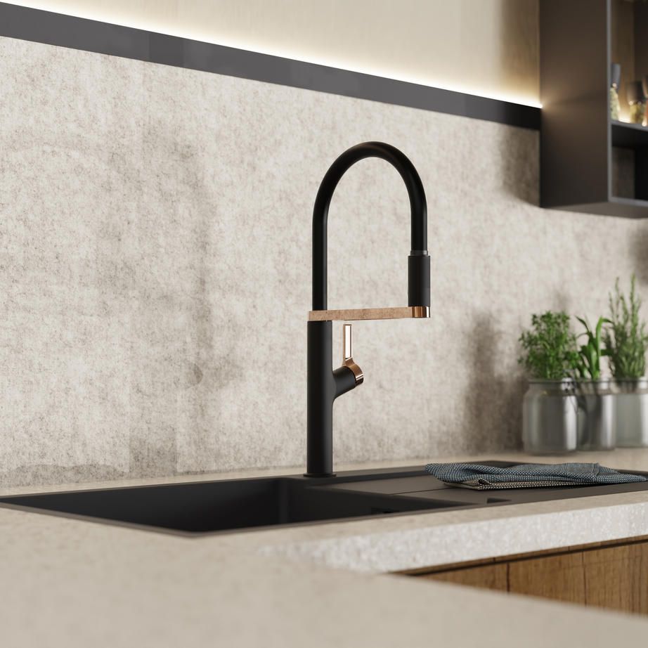 Wasserwerk black and rose gold kitchen faucet mounted on a sink